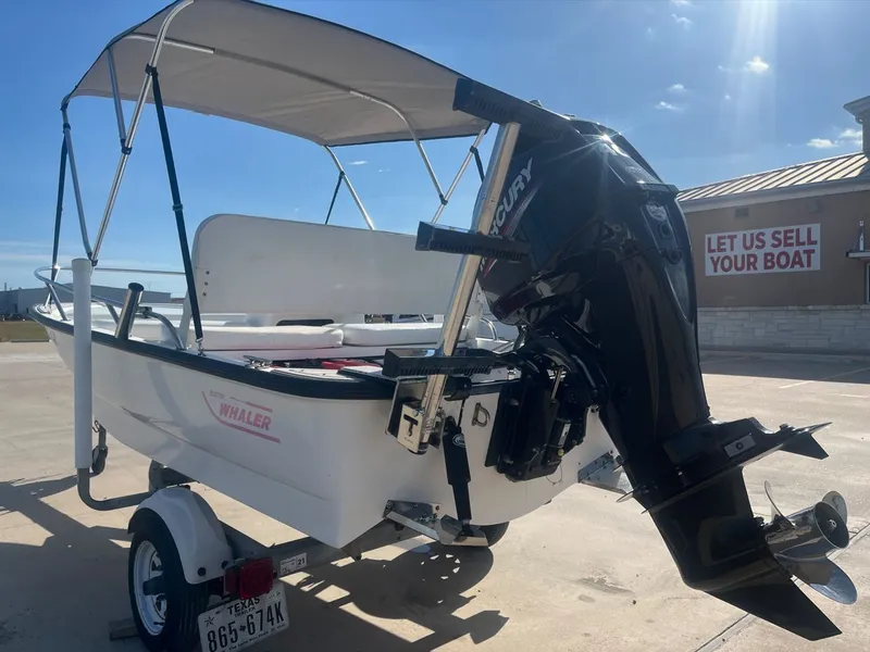 Slide: The Image of 2002 Boston Whaler 130 Sport boat with outboard motor. - 10