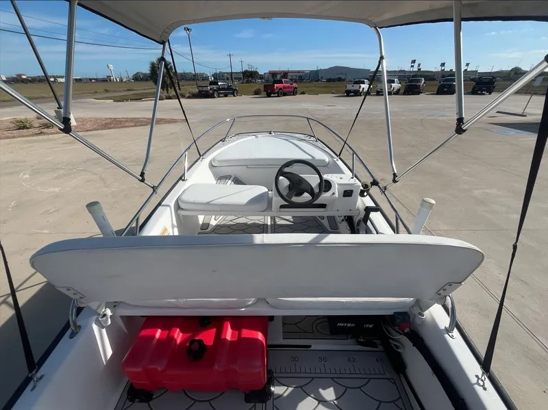 Slide: The Image of Interior view of a 2002 Boston Whaler 130 Sport boat with Bimini top. - 19