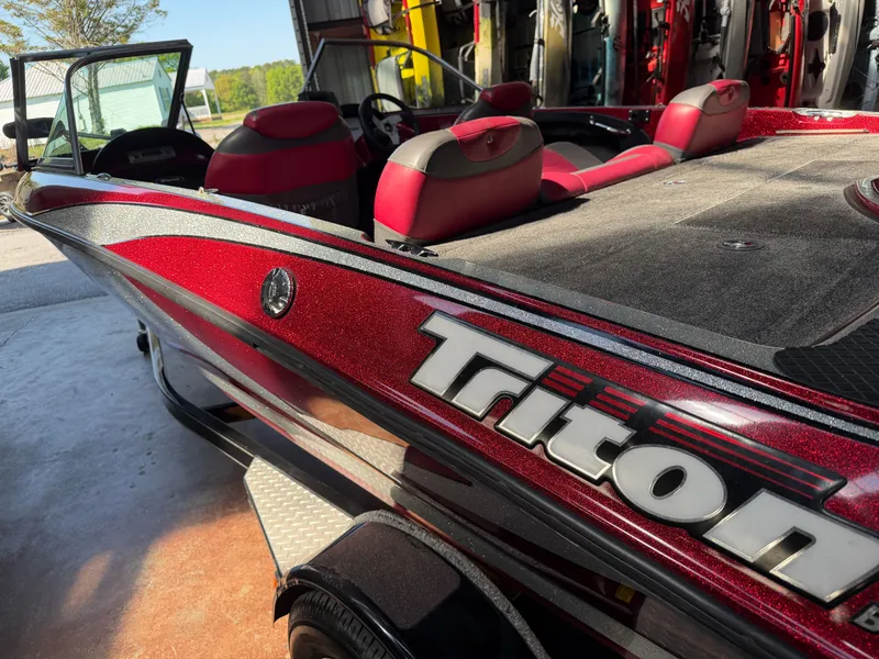 The Image of Red Triton 190 Escape boat from 2010 in a garage. - 1