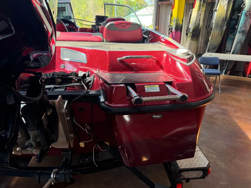 Slide: The Image of Red Triton 190 Escape boat, 2010 model, in a garage. - 15