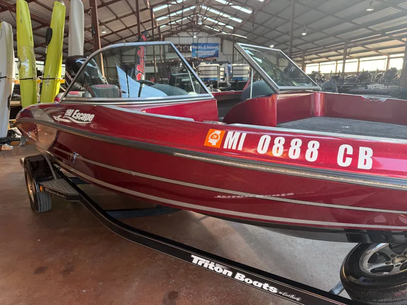 Slide: The Image of Red 2010 Triton 190 Escape boat in warehouse setting. - 3