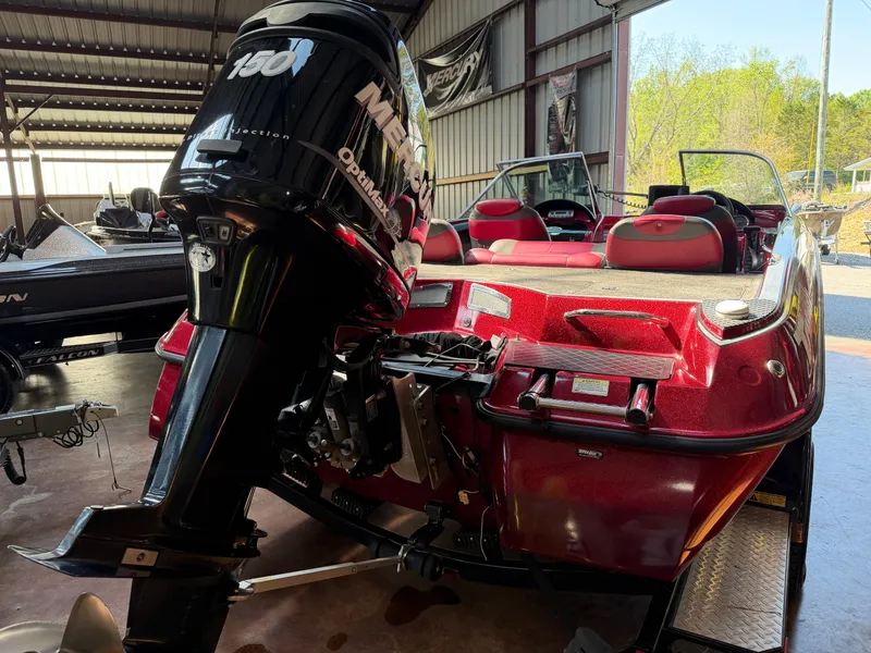 Slide: The Image of Red 2010 Triton 190 Escape with Mercury 150 engine in garage. - 4