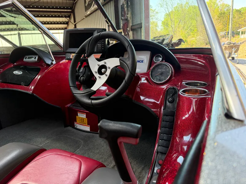 Slide: The Image of Interior of a 2010 Triton 190 Escape boat with red dashboard. - 5