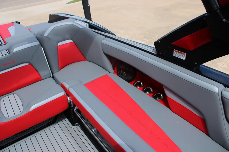Slide: The Image of 2024 MasterCraft XStar S interior with red and gray seating, cup holders, and sleek design. - 10