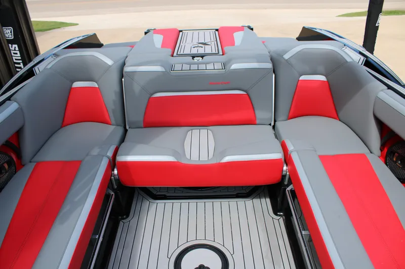 Slide: The Image of 2024 MasterCraft XStar S boat interior with red and gray seating. - 11