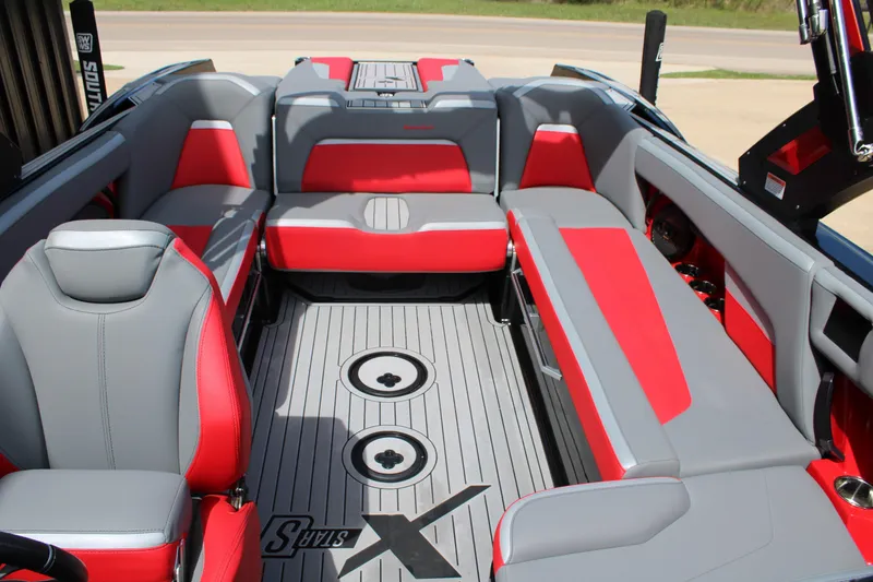 Slide: The Image of 2024 MasterCraft XStar S interior with red and gray seating, spacious layout. - 5