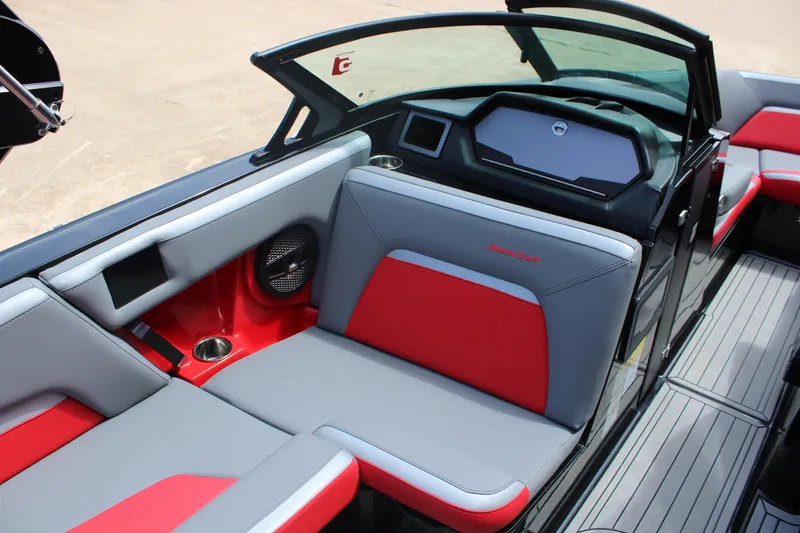 Slide: The Image of 2024 MasterCraft XStar S interior with red and gray seating, modern dashboard, and sleek design. - 9