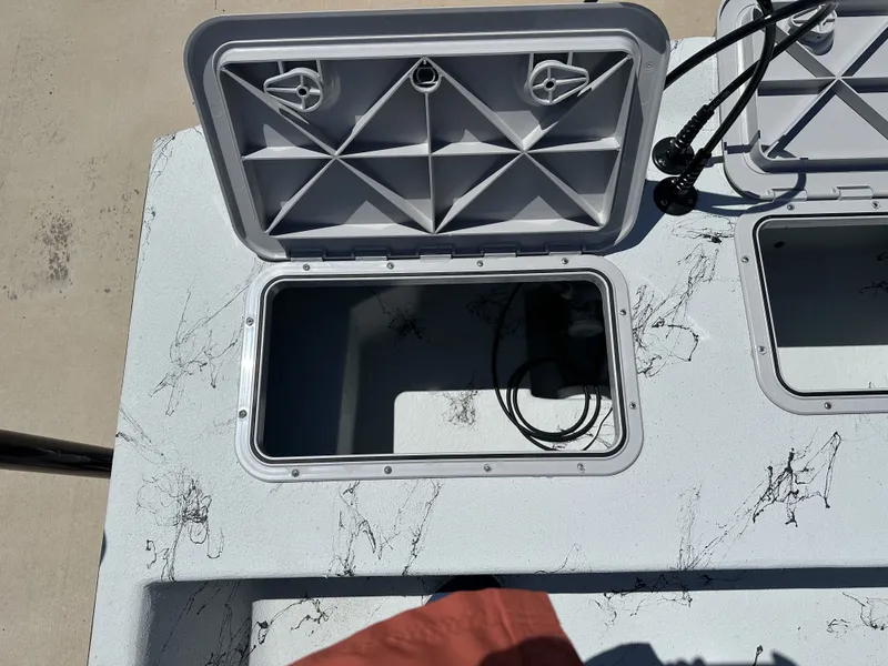 Slide: The Image of Open storage compartments on a 2026 Shoalwater 20' Catamaran. - 18