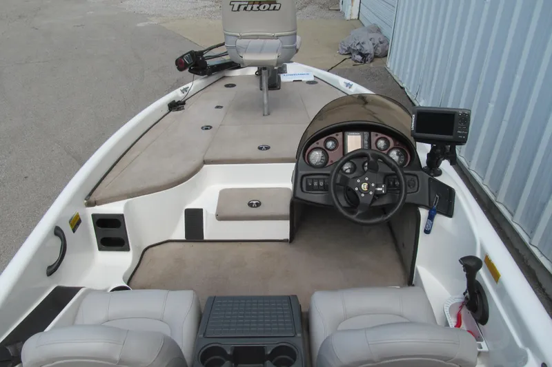 Slide: The Image of 2002 Triton Tr-176 SC boat interior with steering console and seating. - 5