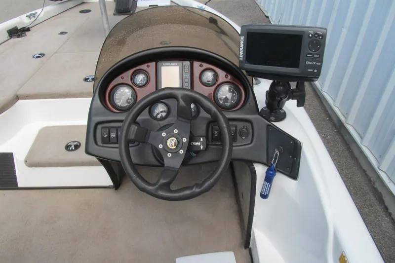 Slide: The Image of 2002 Triton Tr-176 SC boat dashboard with steering wheel and Lowrance Elite-7 HDI fishfinder. - 6