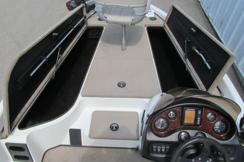 Slide: The Image of 2002 Triton Tr-176 SC boat interior with storage compartments and control panel. - 8