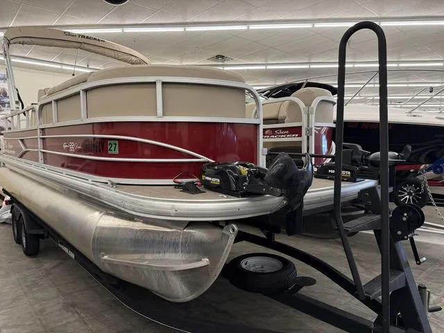 The Image of 2019 Sun Tracker SportFish 22 DLX pontoon boat in a showroom. - 1