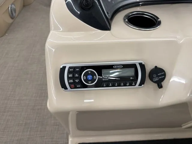 Slide: The Image of Dashboard of 2019 Sun Tracker SportFish 22 DLX with radio and cup holder. - 15