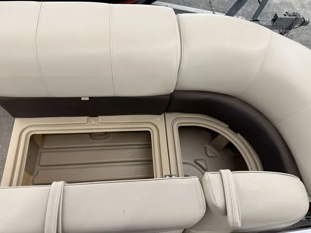 Slide: The Image of 2019 Sun Tracker SportFish 22 DLX seating area with storage compartment. - 6