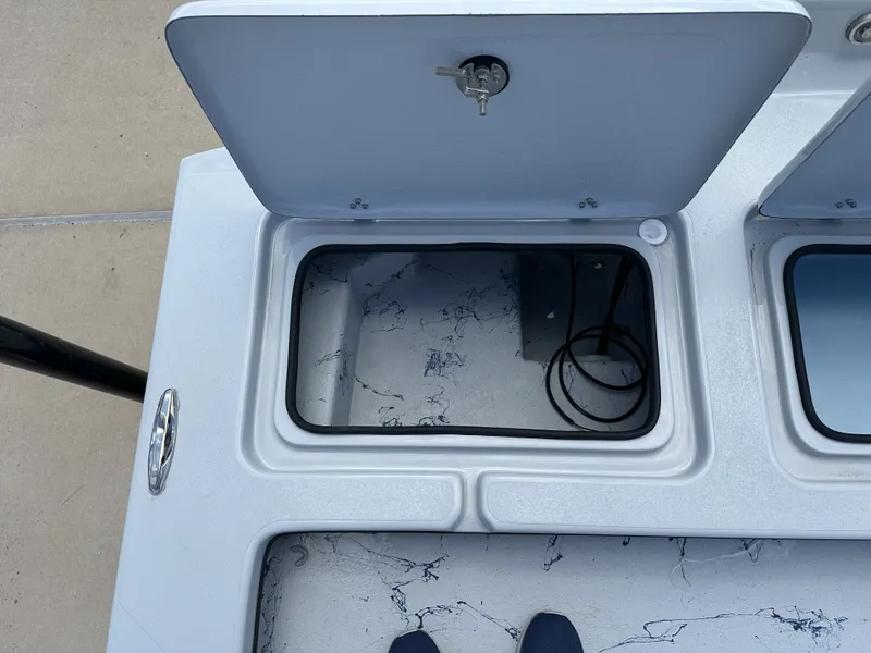 Slide: The Image of Open storage compartment on a 2026 Shoalwater 23' Catamaran. - 19