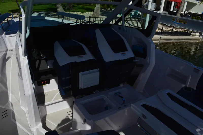 Slide: The Image of 2025 Axopar 29 Sun-Top boat interior with seating and helm station. - 12
