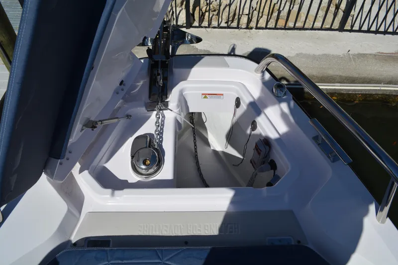 Slide: The Image of 2025 Axopar 29 Sun-Top anchor compartment with chain and winch. - 18