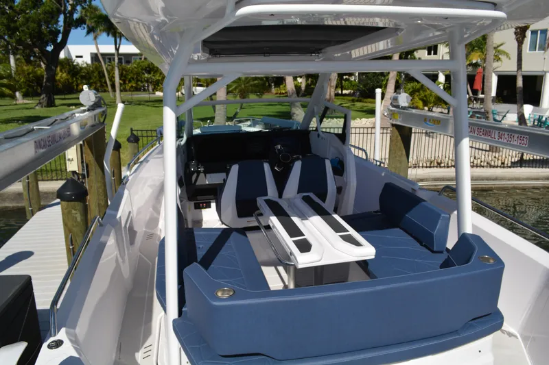 Slide: The Image of 2025 Axopar 29 Sun-Top boat interior with blue seating and modern design. - 3