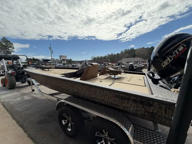 Slide: The Image of 2026 Xpress H20C Crappie boat on trailer under cloudy sky. - 11