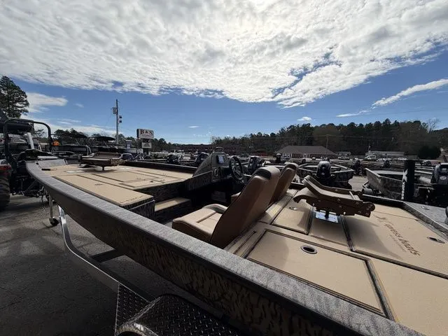 Slide: The Image of 2026 Xpress H20C Crappie boat under cloudy sky in parking lot. - 12