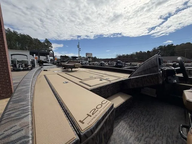 Slide: The Image of 2026 Xpress H20C Crappie boat on a lot under cloudy sky. - 13
