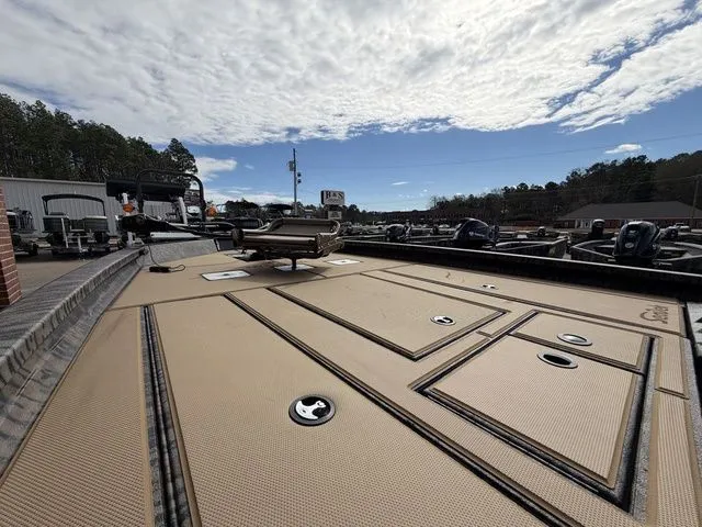 Slide: The Image of 2026 Xpress H20C Crappie boat deck with storage under cloudy sky. - 14