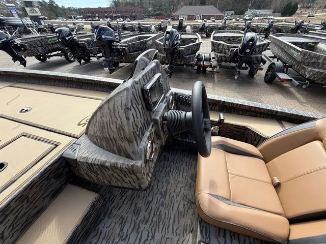 Slide: The Image of Interior of 2026 Xpress H20C Crappie with multiple boats in background. - 17