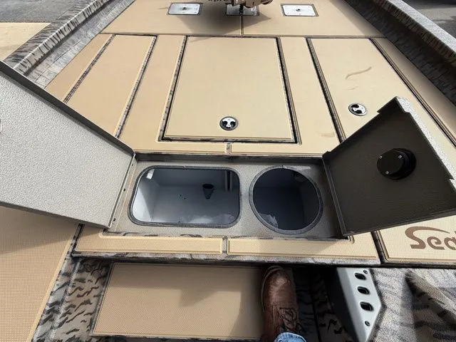 Slide: The Image of Xpress H20C Crappie 2026 boat with open storage compartments. - 21