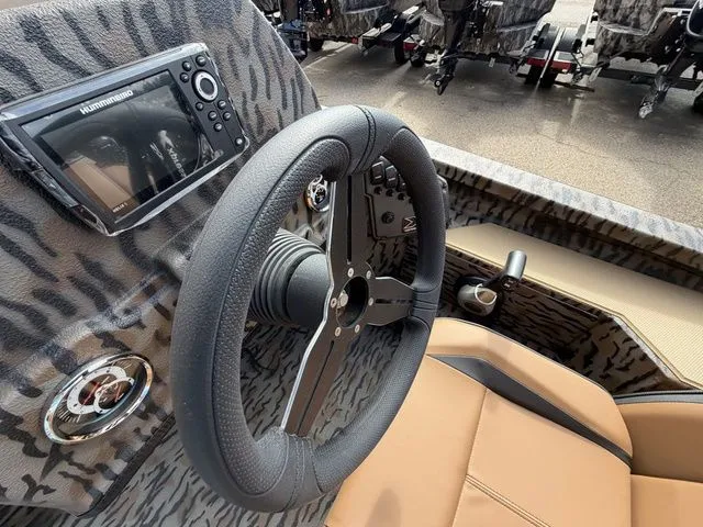 Slide: The Image of 2026 Xpress H20C Crappie boat interior with steering wheel and fish finder. - 22