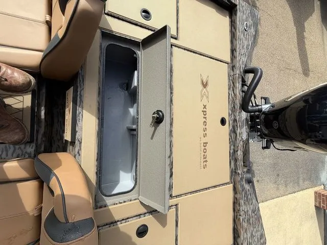 Slide: The Image of 2026 Xpress H20C Crappie boat with storage compartment and cushioned seats. - 29