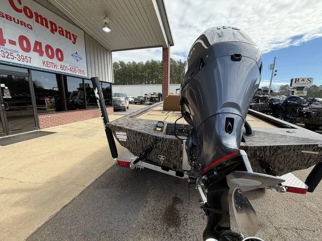 Slide: The Image of 2026 Xpress H20C Crappie boat with outboard motor in a parking lot. - 7
