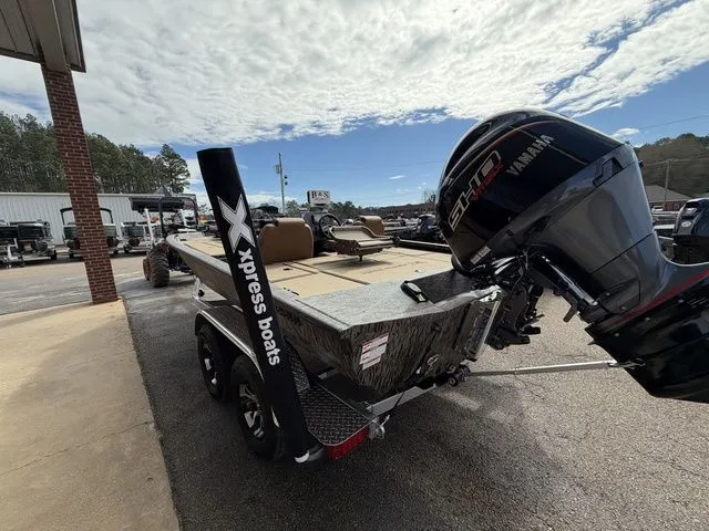 Slide: The Image of Xpress H20C Crappie 2026 boat with Yamaha engine on parking lot. - 9
