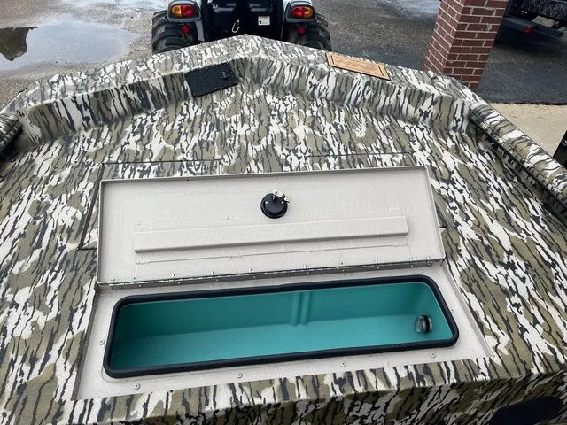 Slide: The Image of Avid 22 Rogue 2026 boat with camouflage pattern and open storage compartment. - 19