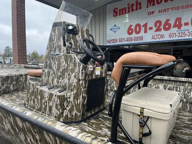 Slide: The Image of Avid 22 Rogue 2026 boat with camouflage pattern and steering console. - 2