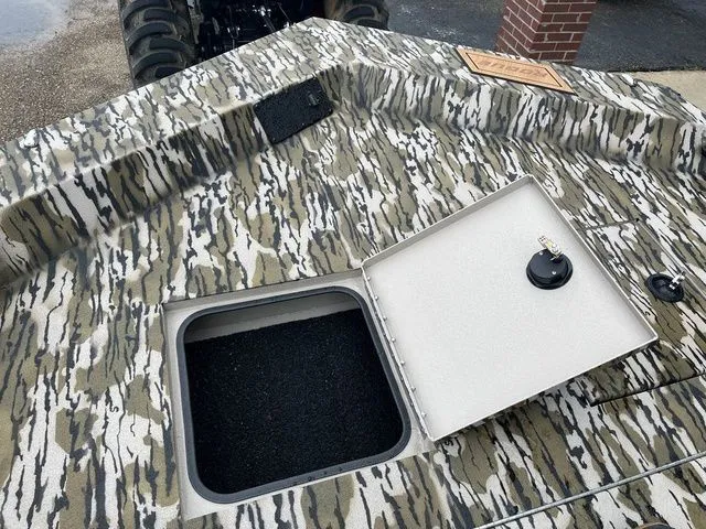 Slide: The Image of Avid 22 Rogue 2026 boat with camouflage pattern and open storage compartment. - 20