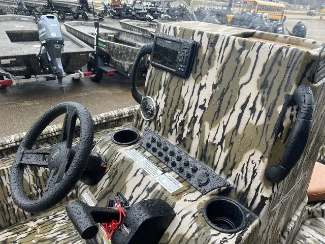 Slide: The Image of Avid 22 Rogue 2026 boat console with camouflage pattern and controls. - 22