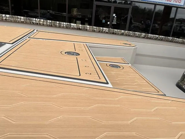 Slide: The Image of Avid 23 Mag 2025 boat deck with wood finish and measurement scale. - 10