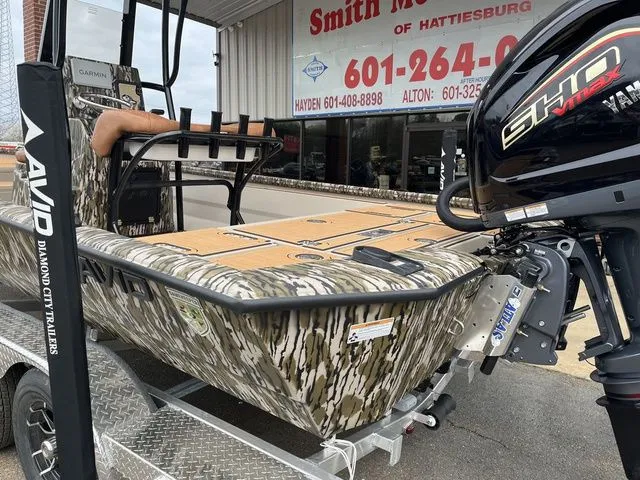 Slide: The Image of Avid 23 Mag boat 2025 with Yamaha engine, on trailer outside store. - 3
