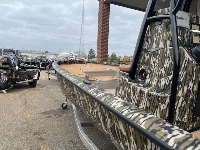 Slide: The Image of 2025 Avid 23 Mag boat with camouflage design and Garmin equipment. - 5