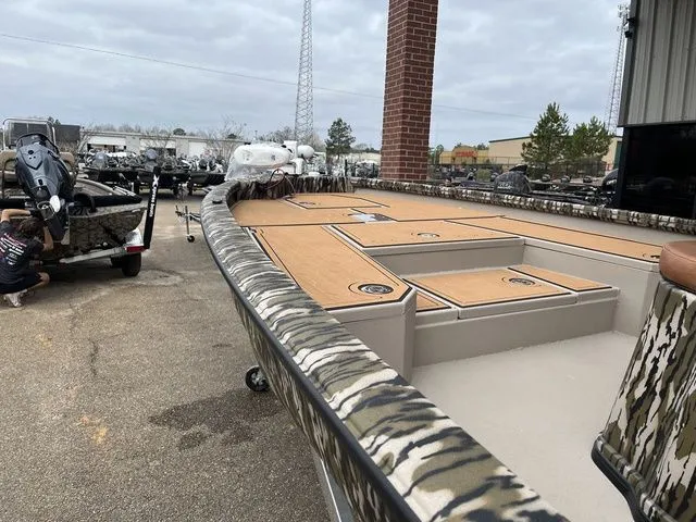 Slide: The Image of Avid 23 Mag 2025 boat with camouflage design and spacious deck. - 6