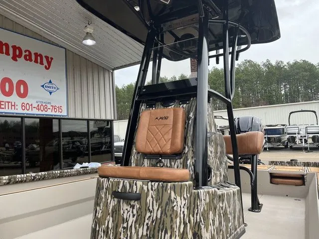 Slide: The Image of Avid 23 Mag 2025 boat with camouflage design and brown seats. - 8