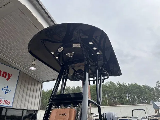 Slide: The Image of Avid 23 Mag 2025 boat with black canopy and LED lights. - 9