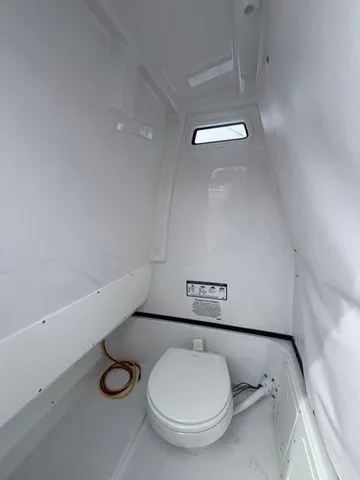 Slide: The Image of Interior of 2026 Sportsman Open 252 Center Console with toilet. - 14