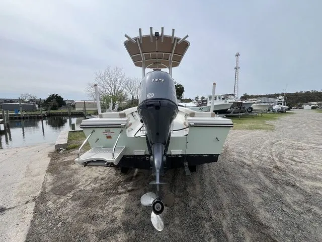Slide: The Image of Rear view of a 2019 Parker 1801 Center Console boat in a parking area. - 6