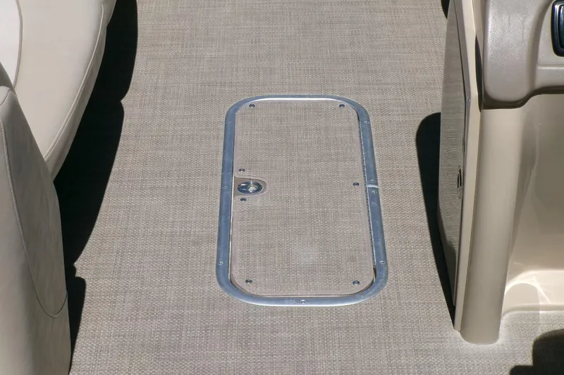 Slide: The Image of 2015 Manitou 25 SES Flip boat interior with carpeted floor and hatch. - 10