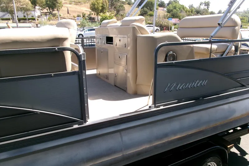 Slide: The Image of 2015 Manitou 25 SES Flip pontoon boat with beige seating and sleek design. - 13