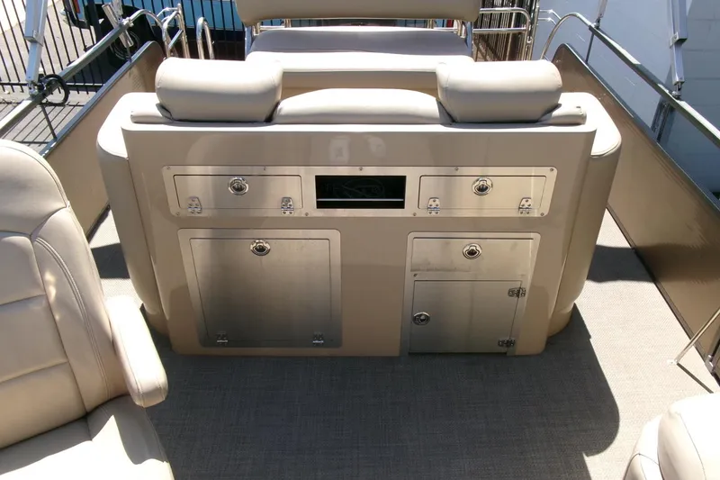 Slide: The Image of Interior of 2015 Manitou 25 SES Flip boat with seating and storage compartments. - 14