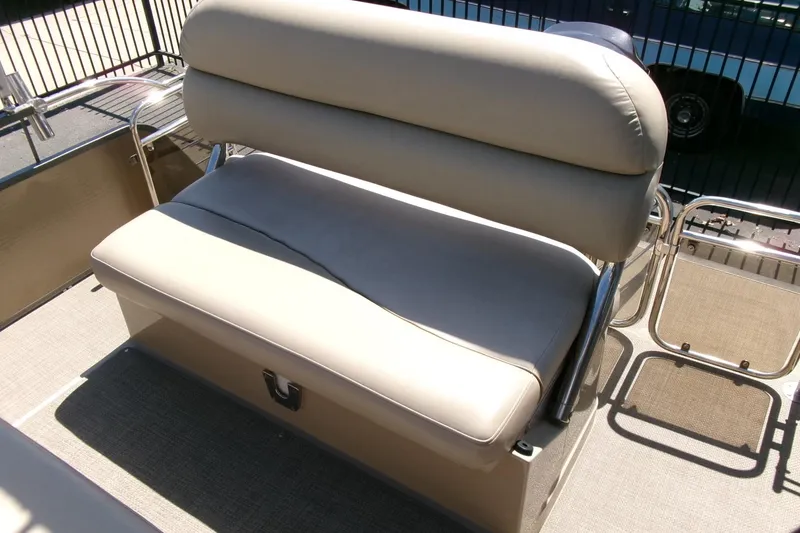 Slide: The Image of 2015 Manitou 25 SES Flip boat seat with beige upholstery and metal frame. - 19