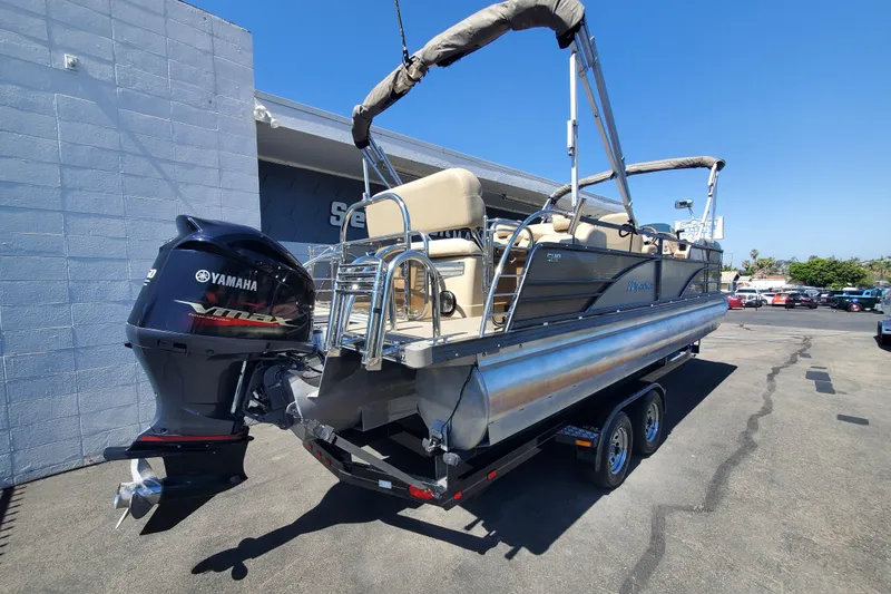 Slide: The Image of 2015 Manitou 25 SES Flip pontoon boat with Yamaha VMAX engine on trailer. - 2