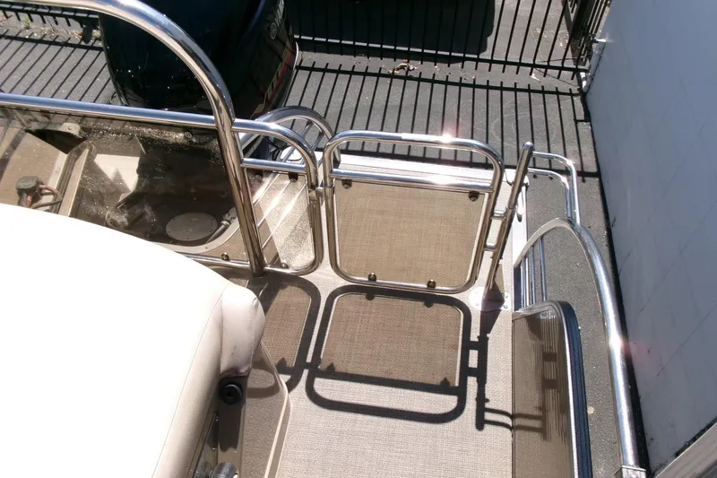 Slide: The Image of 2015 Manitou 25 SES Flip boat deck with stainless steel railing and seating. - 22